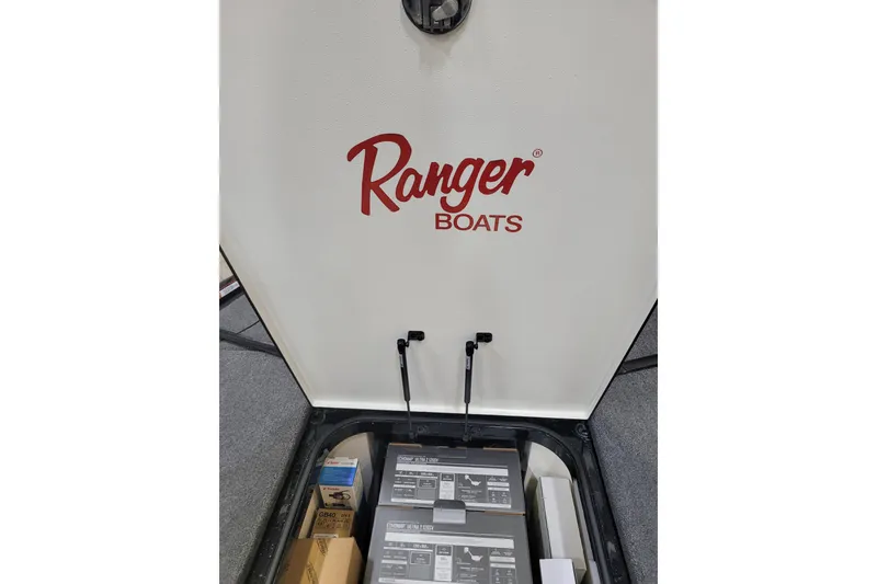 Slide: The Image of 2025 Ranger Z520R Cup-Equipped boat interior with storage compartment and logo. - 16