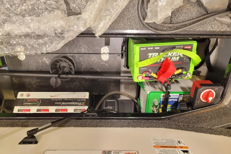 Slide: The Image of 2025 Ranger Z520R Cup-Equipped boat battery compartment with Tracker lithium battery setup. - 18