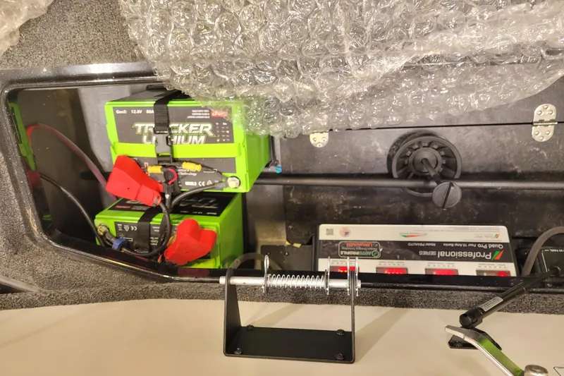 Slide: The Image of 2025 Ranger Z520R Cup-Equipped boat battery compartment with Tracker Lithium batteries and charger. - 19