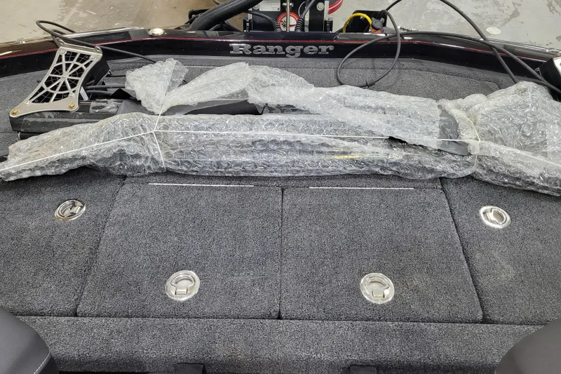 Slide: The Image of 2025 Ranger Z520R Cup-Equipped boat deck with bubble-wrapped equipment. - 21