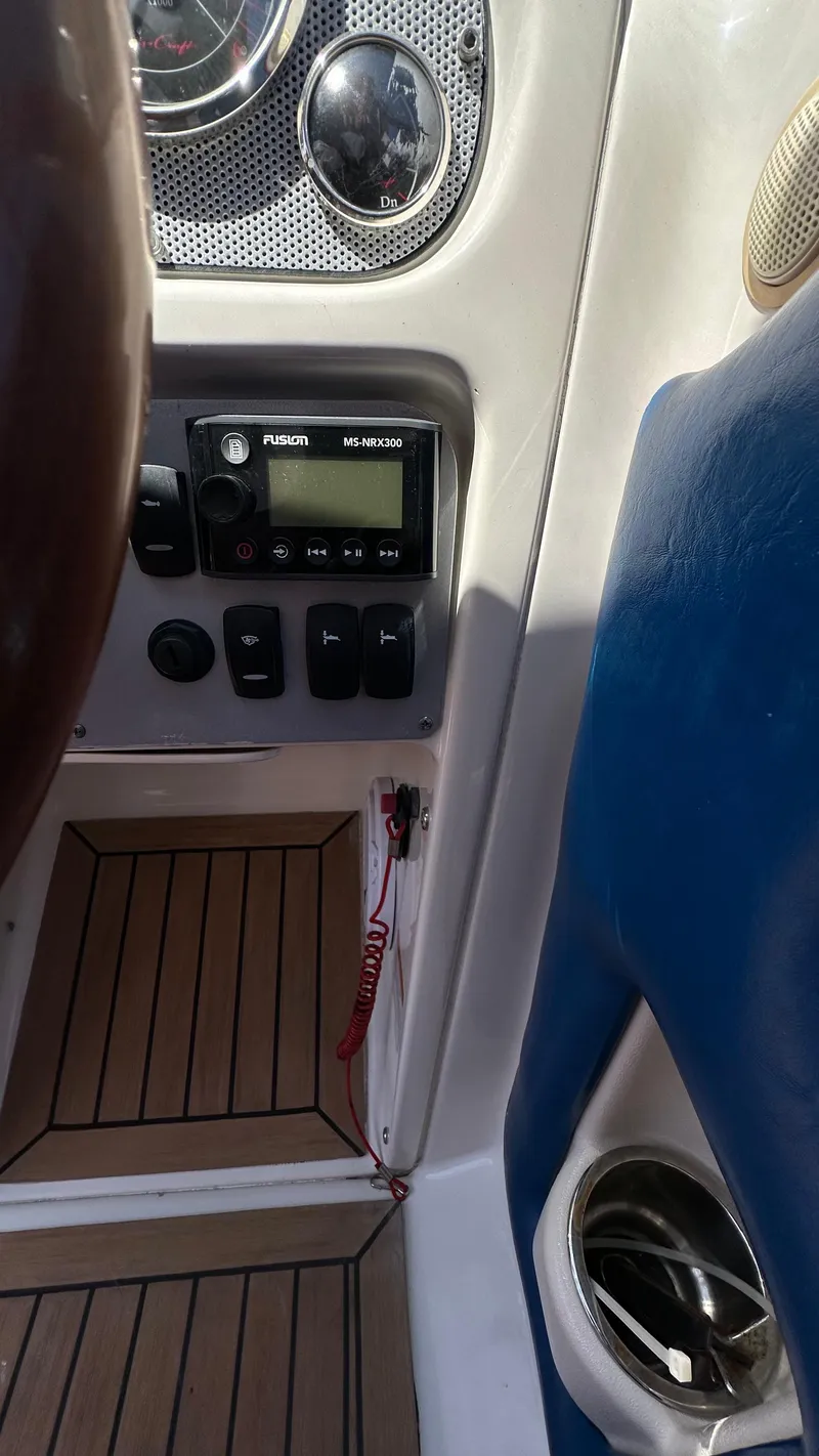 Slide: The Image of 2009 Chris-Craft Corsair 25 dashboard with control panel and wood flooring. - 10