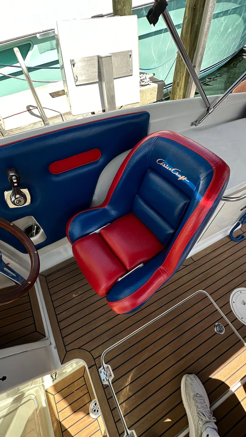 Slide: The Image of 2009 Chris-Craft Corsair 25 boat interior with red and blue seating. - 12