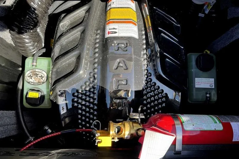 Slide: The Image of Engine compartment of 2026 Supra SL with visible components and fire extinguisher. - 17