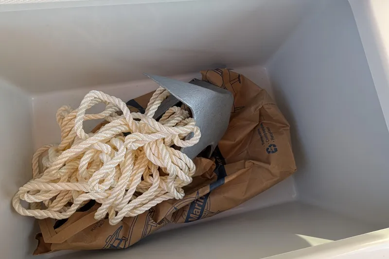 Slide: The Image of Rope and anchor inside a storage compartment of a 2013 Duffy Snug Harbor 18 boat. - 11