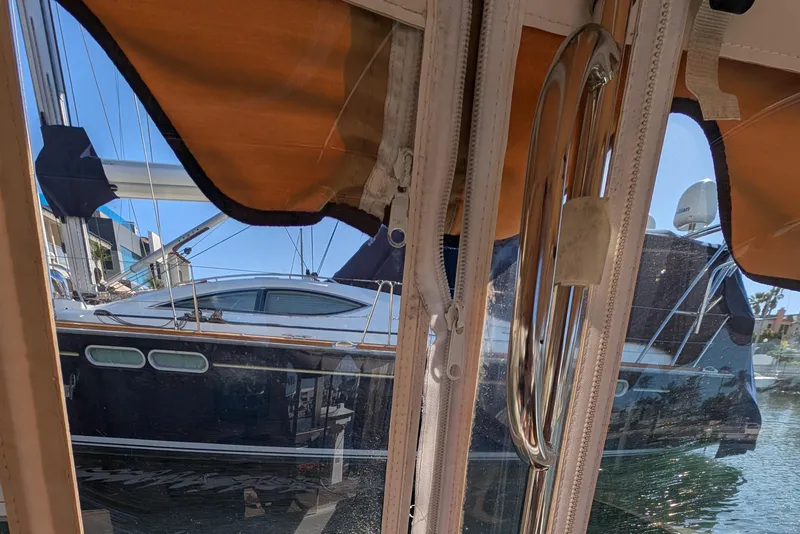 Slide: The Image of View from inside a 2013 Duffy Snug Harbor 18 boat, showing marina and neighboring yacht. - 12