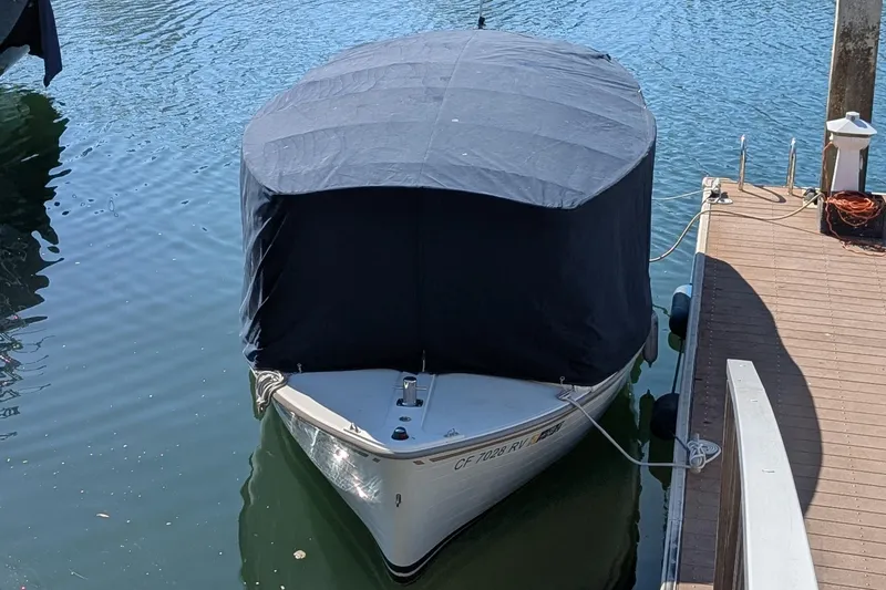 Slide: The Image of Covered 2013 Duffy Snug Harbor 18 boat docked on calm water. - 15