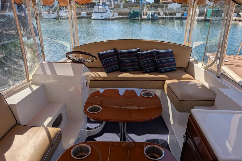 Slide: The Image of Interior of 2013 Duffy Snug Harbor 18 boat with seating and striped cushions. - 3