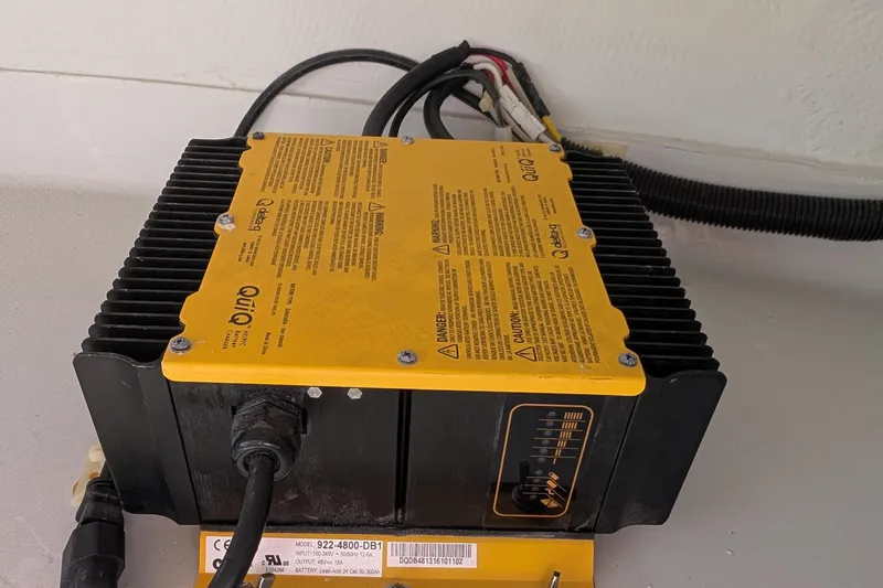 Slide: The Image of Battery charger for 2013 Duffy Snug Harbor 18 boat, featuring yellow casing and cables. - 6