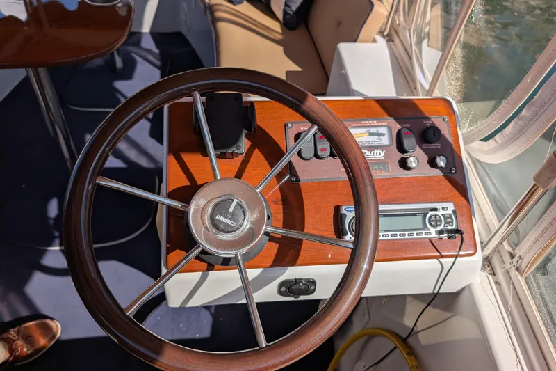 Slide: The Image of Steering wheel and dashboard of a 2013 Duffy Snug Harbor 18 boat. - 8