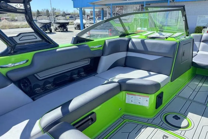 Slide: The Image of 2021 Moomba Mondo boat interior with green and gray seating, modern design. - 4