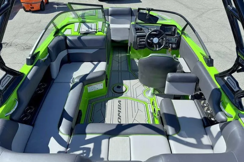 Slide: The Image of 2021 Moomba Mondo boat interior with green accents and spacious seating. - 8