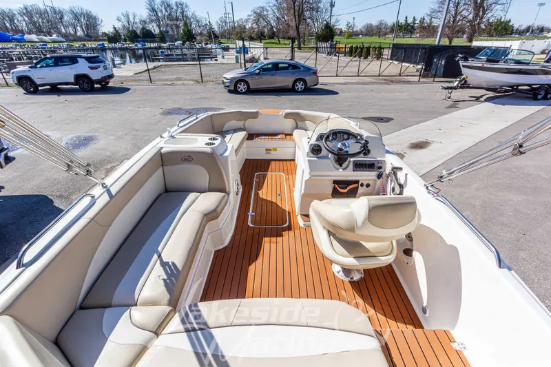 Slide: The Image of 2017 NauticStar 193 SC boat interior with beige seating and wood-style flooring. - 10