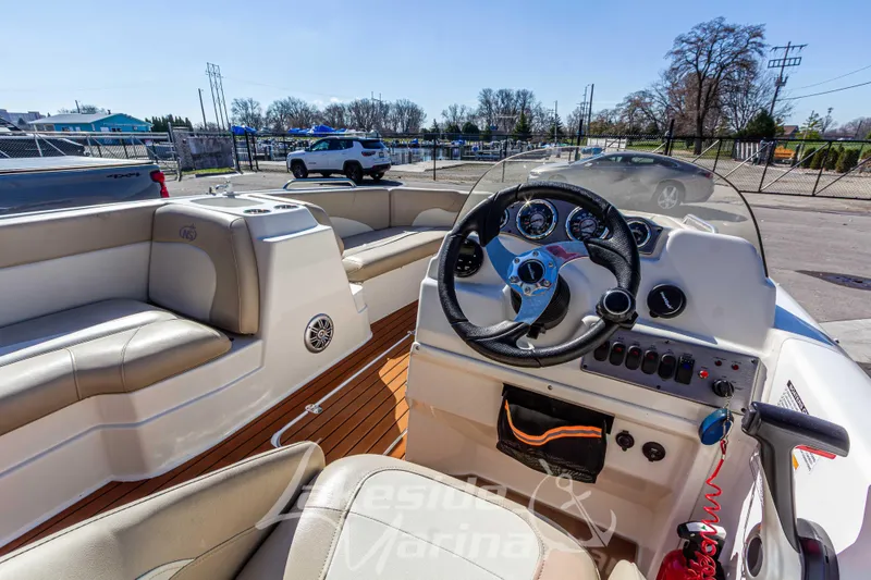 Slide: The Image of 2017 NauticStar 193 SC boat interior with steering wheel and seating. - 15