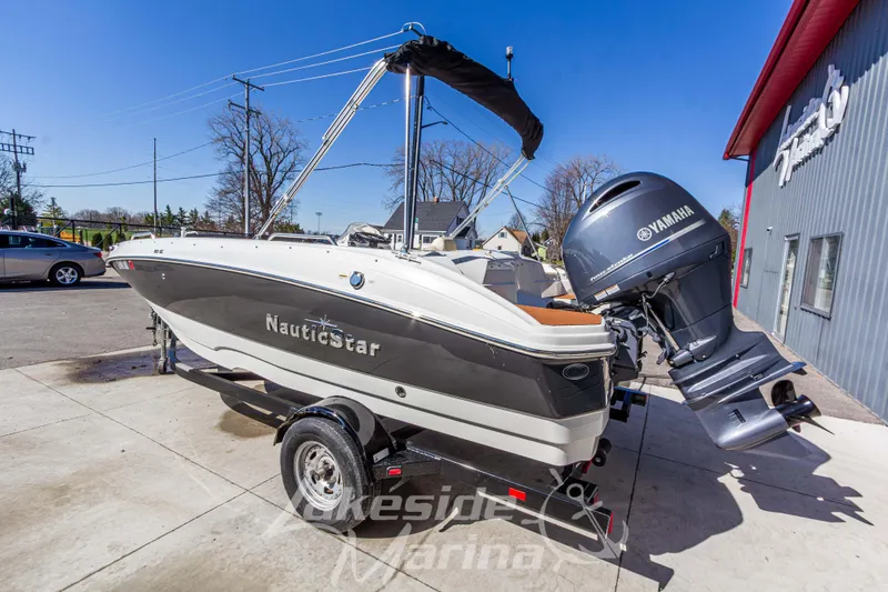 Slide: The Image of 2017 NauticStar 193 SC boat with Yamaha engine on trailer at marina. - 3