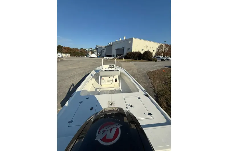 Slide: The Image of 2024 Mako 18 LTS boat parked outdoors near industrial building. - 4