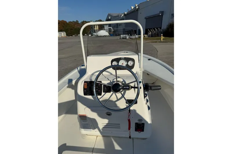 Slide: The Image of 2024 Mako 18 LTS boat console with steering wheel and gauges. - 5