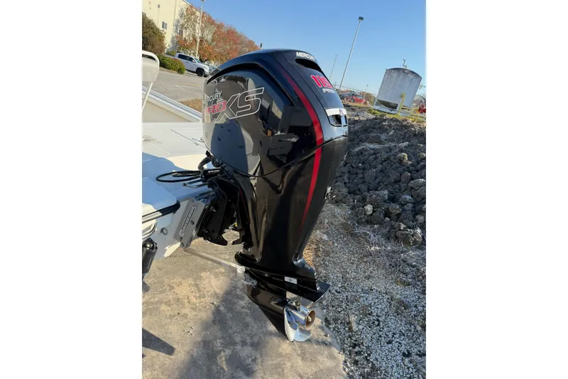 Slide: The Image of 2024 Mako 18 LTS boat with Mercury Pro XS outboard motor, parked outdoors. - 7