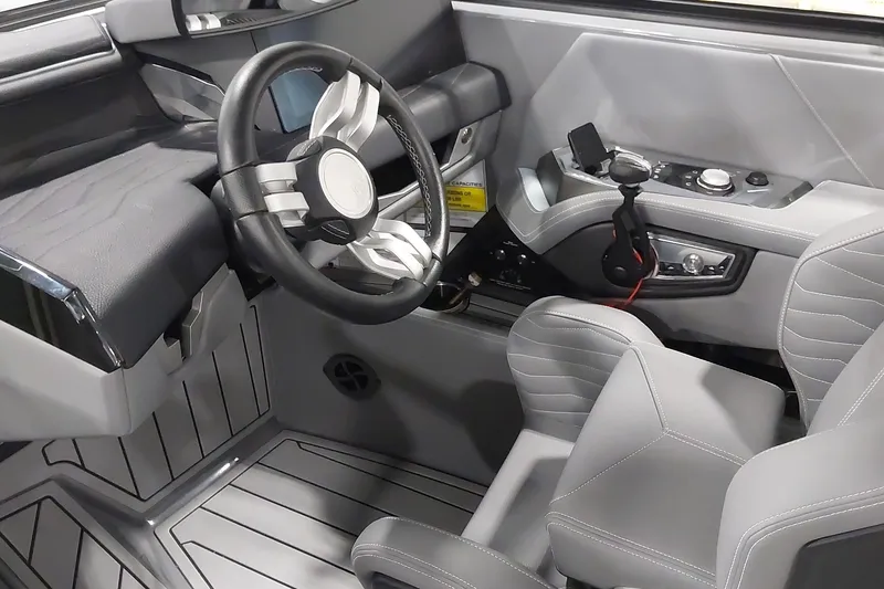 Slide: The Image of 2025 Nautique Super Air Nautique G23 Paragon cockpit with modern steering and controls. - 10