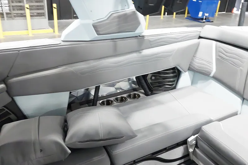 Slide: The Image of 2025 Nautique Super Air Nautique G23 Paragon interior with luxurious seating and cup holders. - 13