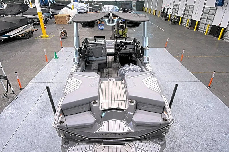 Slide: The Image of 2025 Nautique Super Air Nautique G23 Paragon boat in a showroom setting. - 4