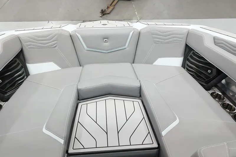 Slide: The Image of 2025 Nautique Super Air Nautique G23 Paragon interior with sleek gray seating and cup holders. - 9