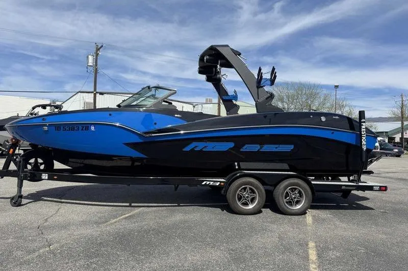 The Image of 2022 MB Sport B52 boat in blue and black on a trailer, parked outdoors. - 0
