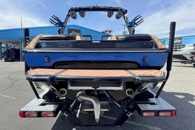 Slide: The Image of 2022 MB Sport B52 boat, rear view, in a marina setting. - 10