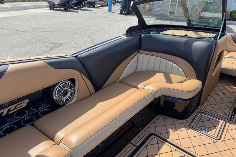 Slide: The Image of 2022 MB Sport B52 boat interior with tan and black seating, featuring a speaker system. - 15