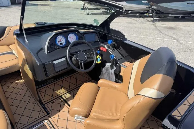 Slide: The Image of 2022 MB Sport B52 boat interior with tan leather seating and modern dashboard controls. - 3