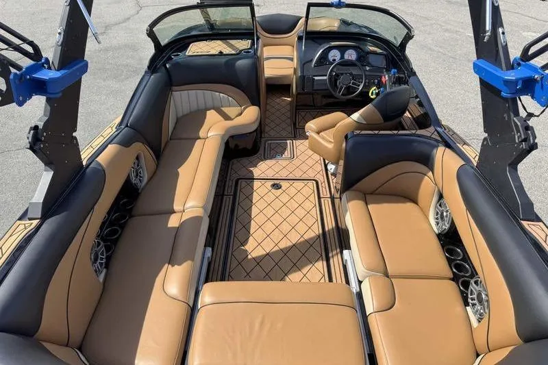 Slide: The Image of 2022 MB Sport B52 boat interior with tan leather seating and modern dashboard. - 4