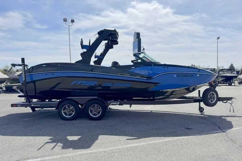 Slide: The Image of 2022 MB Sport B52 boat on trailer in parking lot under cloudy sky. - 7