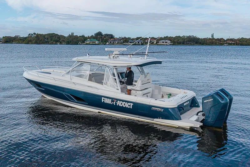 Slide: The Image of 2024 Intrepid 41 Valor boat on calm water, featuring sleek design and powerful engines. - 10