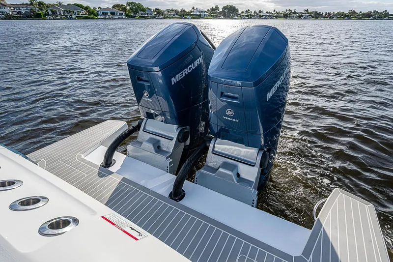 Slide: The Image of 2024 Intrepid 41 Valor boat with dual Mercury Verado outboard engines on a calm lake. - 11