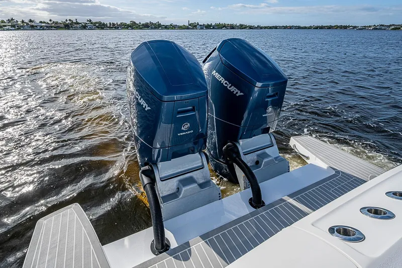 Slide: The Image of Twin Mercury Verado engines on 2024 Intrepid 41 Valor boat, cruising on open water. - 13