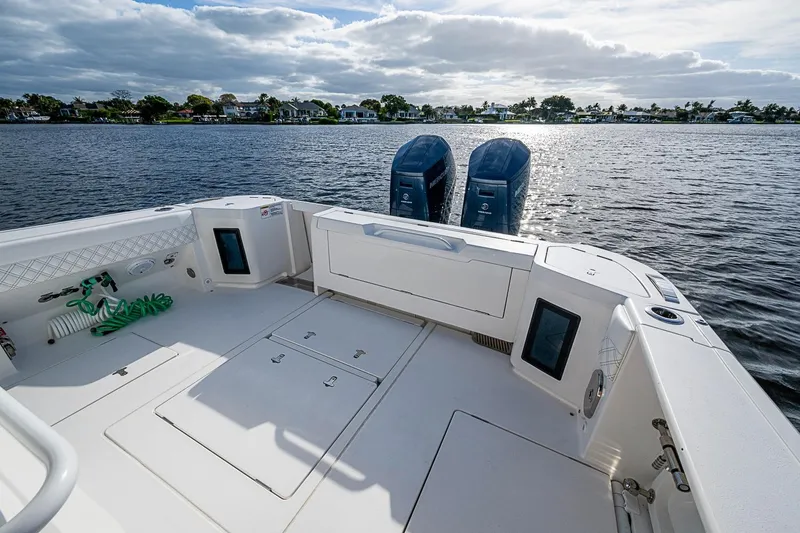 Slide: The Image of 2024 Intrepid 41 Valor boat deck with twin engines on a sunny day. - 15