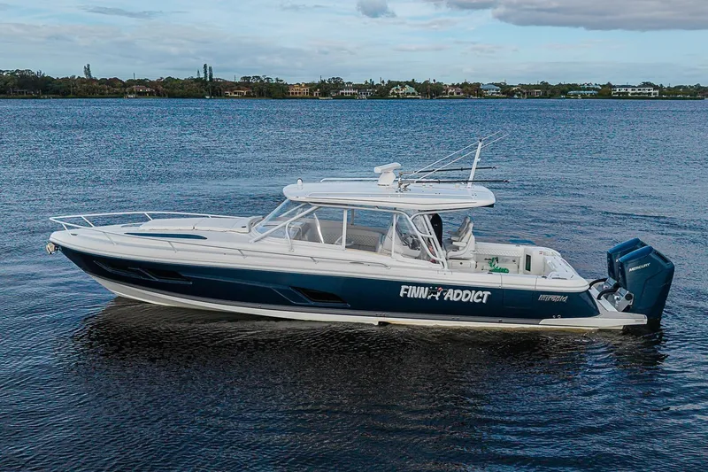 Slide: The Image of 2024 Intrepid 41 Valor boat on calm water, side view. - 2