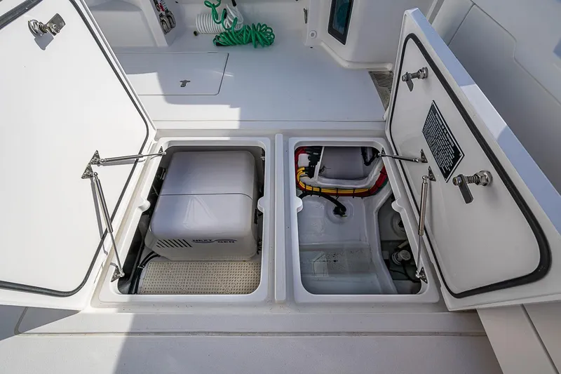 Slide: The Image of 2024 Intrepid 41 Valor boat storage compartments with equipment and wiring. - 21