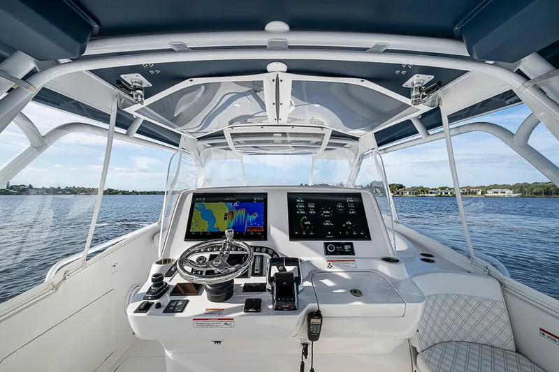 Slide: The Image of 2024 Intrepid 41 Valor helm with advanced navigation system on open water. - 24