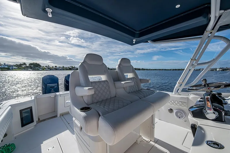 Slide: The Image of 2024 Intrepid 41 Valor boat interior with luxurious seating and scenic water view. - 26