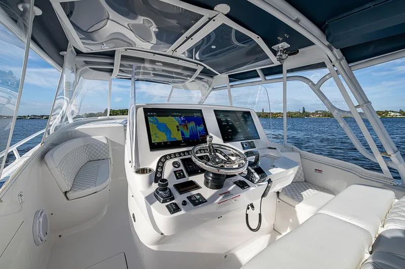 Slide: The Image of 2024 Intrepid 41 Valor helm with advanced navigation displays on open water. - 27