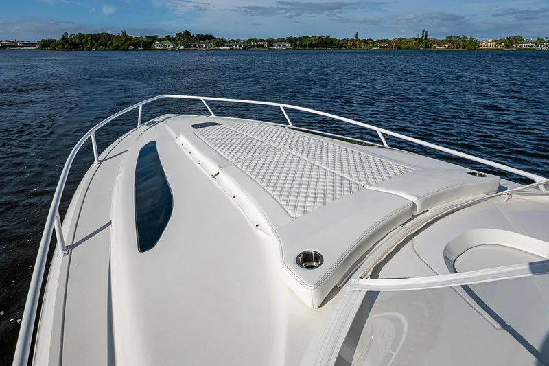 Slide: The Image of 2024 Intrepid 41 Valor boat with sleek deck design on calm water. - 30