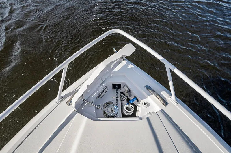 Slide: The Image of Bow view of 2024 Intrepid 41 Valor boat with anchor compartment open. - 31