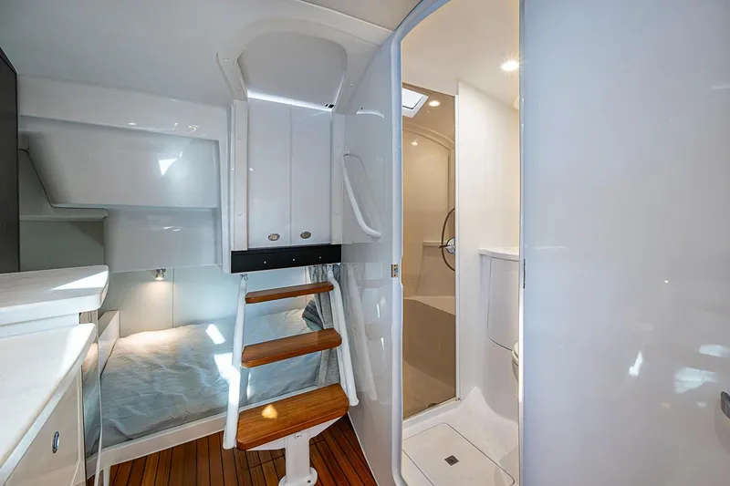 Slide: The Image of 2024 Intrepid 41 Valor interior cabin with wooden steps and modern bathroom. - 36