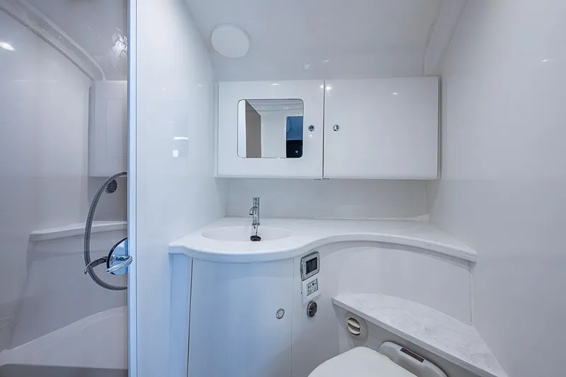 Slide: The Image of Luxurious bathroom interior of 2024 Intrepid 41 Valor yacht, featuring sleek white design. - 39