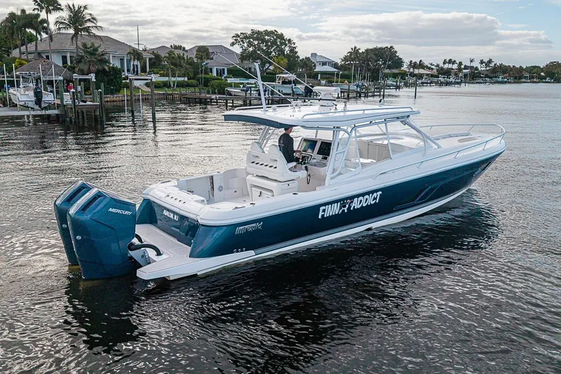 Slide: The Image of 2024 Intrepid 41 Valor boat on water, featuring sleek design and powerful Mercury engines. - 8