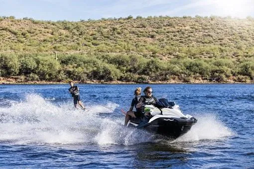 Slide: The Image of 2026 Kawasaki ULTRA 160LX jet ski on a lake with riders enjoying the water. - 6