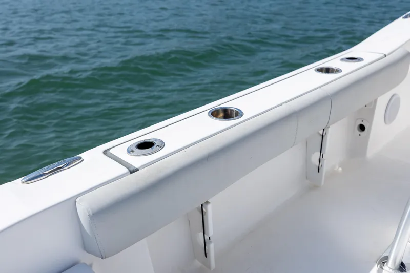 Slide: The Image of 2020 Sea Fox 206 Commander boat interior with rod holders, on calm water. - 19