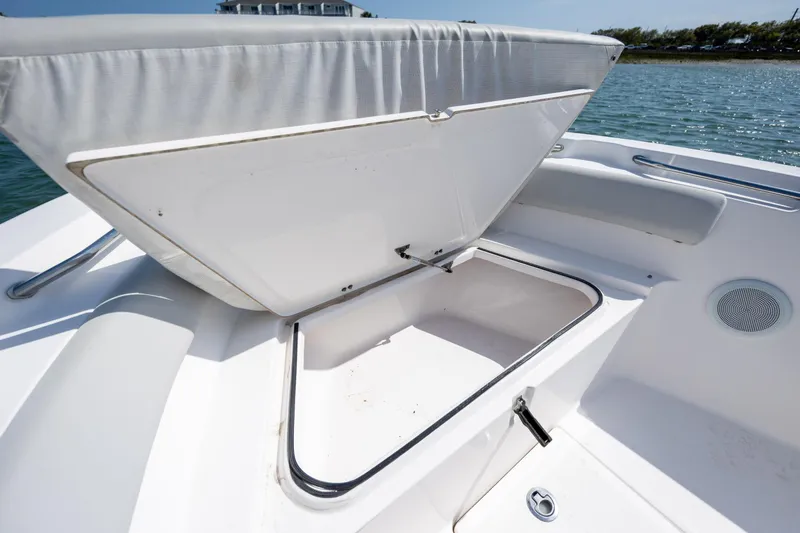 Slide: The Image of Open storage compartment on a 2020 Sea Fox 206 Commander boat, near water. - 9