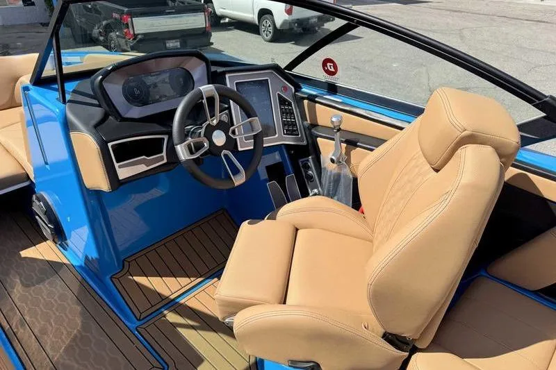 Slide: The Image of 2022 MasterCraft XT22 boat interior with tan seats and modern dashboard. - 12