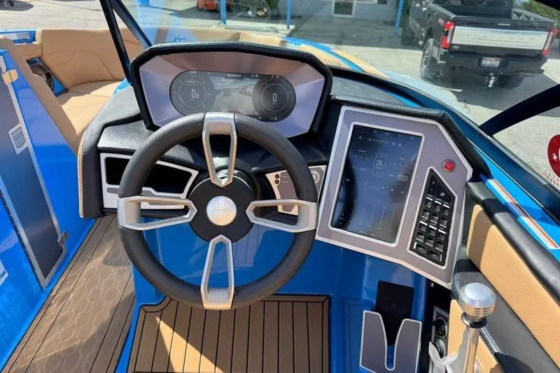Slide: The Image of 2022 MasterCraft XT22 boat dashboard with steering wheel and digital display. - 15